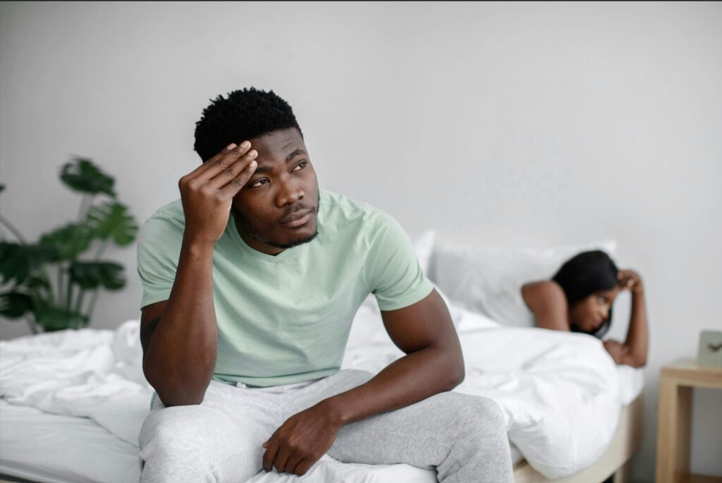 A couple in bed. What detachment from a relationship looks like..