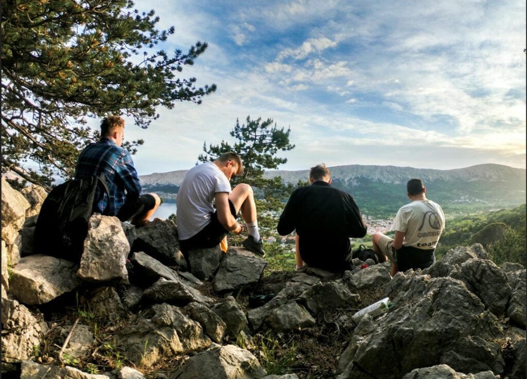 group of men sitting outside and bonding and symbolizing infidelity therapy for men