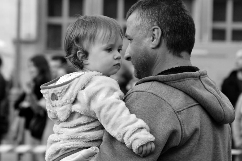 father carrying child thinking about how to be a good father after betrayal