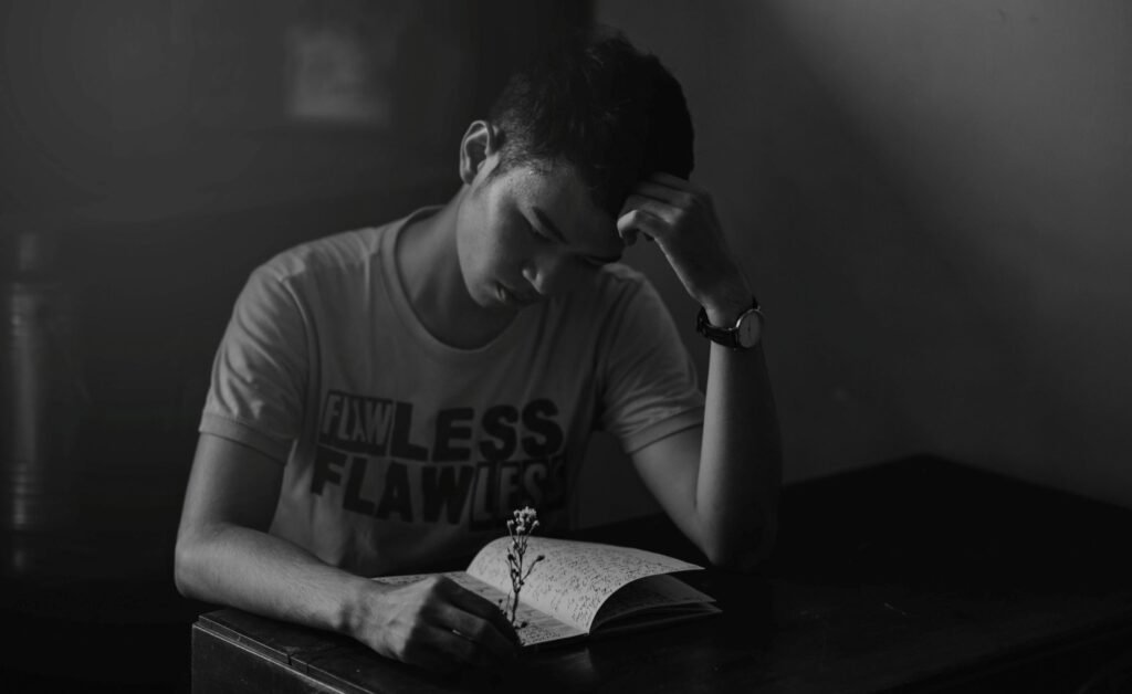 man journaling for emotional regulation after betrayal by wife