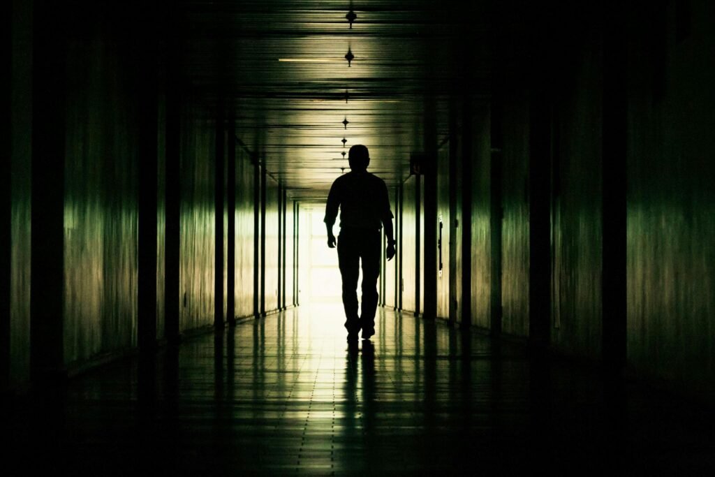 man walking towards lihjt depicting men and emotional healing aftermath