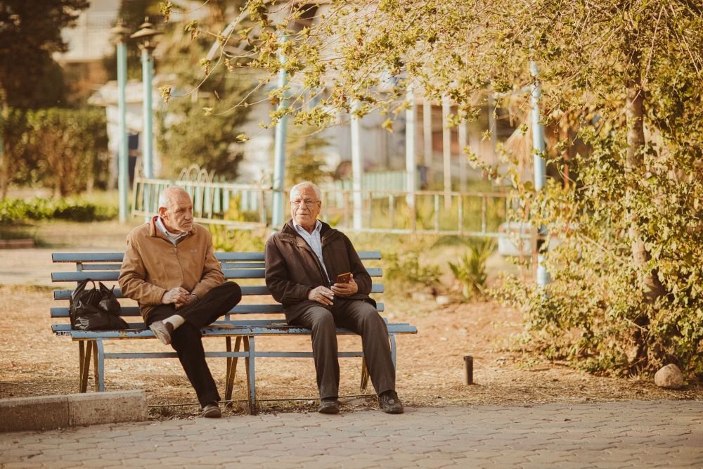 two men sitting talking on how to cope with infidelity